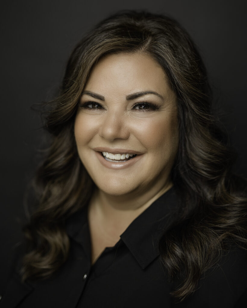 professional headshot of hair and makeup artist on black backdrop
